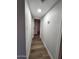 Inviting hallway featuring wood-look floors and fresh paint leading to other rooms at 954 E Henry St, Tempe, AZ 85288