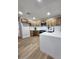 Bright kitchen features wood cabinets, quartz counters, stainless steel appliances, and light-colored wood floors at 954 E Henry St, Tempe, AZ 85288