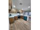Open kitchen with light wood cabinets, quartz counters, stainless steel appliances, and bright wood floors at 954 E Henry St, Tempe, AZ 85288