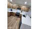 Well-lit kitchen with modern appliances, sleek white countertops, and stylish wood cabinets at 954 E Henry St, Tempe, AZ 85288