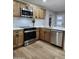 Updated kitchen featuring stainless steel appliances, wood cabinets, and a white subway tile backsplash at 954 E Henry St, Tempe, AZ 85288