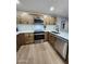 Updated kitchen featuring stainless steel appliances, wood cabinets, and a white subway tile backsplash at 954 E Henry St, Tempe, AZ 85288