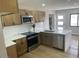 Well-lit kitchen with stainless steel appliances, updated cabinetry, and sleek countertops at 954 E Henry St, Tempe, AZ 85288