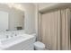 Classic bathroom with a large mirror, a sink, and a shower-tub combination at 9814 W Long Hills Dr, Sun City, AZ 85351