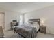 Comfortable bedroom with a large bed, a small desk and neutral decor at 9814 W Long Hills Dr, Sun City, AZ 85351