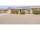 Charming home exterior featuring a well-manicured lawn, gravel, and a welcoming facade at 9814 W Long Hills Dr, Sun City, AZ 85351