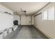 Spacious garage featuring ample storage space, a large door, and a window for natural light at 9814 W Long Hills Dr, Sun City, AZ 85351