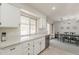 Well-lit kitchen area with a dishwasher and view into the dining room area at 9814 W Long Hills Dr, Sun City, AZ 85351