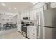 Stylish kitchen with white cabinets and stainless steel appliances open to the dining area at 9814 W Long Hills Dr, Sun City, AZ 85351