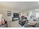 Cozy living room with neutral tones and comfortable seating, seamlessly connecting to the kitchen at 9814 W Long Hills Dr, Sun City, AZ 85351