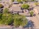View of a home featuring a tile roof, a three car garage, and mature landscaping at 9998 W Prospector Dr, Queen Creek, AZ 85144
