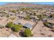 Wide aerial view of a residential area featuring well-maintained homes and horse properties, surrounded by desert landscape at 9998 W Prospector Dr, Queen Creek, AZ 85144