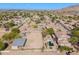 Expansive aerial view of a desert property featuring horse facilities and lush desert landscaping at 9998 W Prospector Dr, Queen Creek, AZ 85144