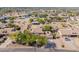 Expansive aerial view of a desert property featuring horse facilities, landscaping, and desert surroundings at 9998 W Prospector Dr, Queen Creek, AZ 85144