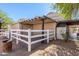 View of a backyard with a garage, shed, pergola and white fencing to enclose the area at 9998 W Prospector Dr, Queen Creek, AZ 85144