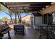 Backyard features a covered patio with a grill, a shed for storage and an outdoor seating area, great for relaxing outdoors at 9998 W Prospector Dr, Queen Creek, AZ 85144