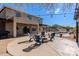 Inviting backyard with a cozy fire pit area, ample seating, and a pool area perfect for relaxing and entertaining at 9998 W Prospector Dr, Queen Creek, AZ 85144