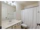 Clean bathroom with neutral color scheme, shower curtain, and vanity with good storage at 9998 W Prospector Dr, Queen Creek, AZ 85144