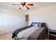 Comfortable bedroom with ceiling fan, double closets, and an ensuite bath at 9998 W Prospector Dr, Queen Creek, AZ 85144