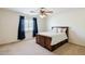 A bedroom featuring a queen size bed with storage drawers, ceiling fan, and natural light at 9998 W Prospector Dr, Queen Creek, AZ 85144