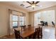 Warm dining room featuring a wooden table, neutral walls, and arched doorway view to the office at 9998 W Prospector Dr, Queen Creek, AZ 85144