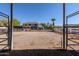 Large, fenced outdoor area, perfect for horses, with easy access through metal gates on a sunny day at 9998 W Prospector Dr, Queen Creek, AZ 85144