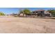 Extensive outdoor space fully enclosed by a white fence; ideal for horses to roam and graze safely at 9998 W Prospector Dr, Queen Creek, AZ 85144