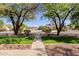 Beautifully landscaped front yard with mature trees, providing privacy and enhancing curb appeal of the home at 9998 W Prospector Dr, Queen Creek, AZ 85144