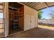 Spacious horse stall with metal enclosure and additional storage space for equestrian needs and supplies at 9998 W Prospector Dr, Queen Creek, AZ 85144