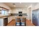Kitchen featuring granite countertops, stainless steel appliances, white cabinets, and a breakfast bar at 9998 W Prospector Dr, Queen Creek, AZ 85144
