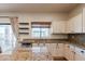 Bright kitchen with granite counters, stainless steel appliances, ample cabinet space, and a sliding glass door at 9998 W Prospector Dr, Queen Creek, AZ 85144
