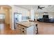 Kitchen island with granite countertops, stainless steel refrigerator, white cabinetry, and barstool seating at 9998 W Prospector Dr, Queen Creek, AZ 85144