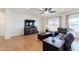 Cozy living room featuring neutral paint, tile flooring, ceiling fan, and a comfortable leather sectional at 9998 W Prospector Dr, Queen Creek, AZ 85144