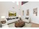 Bright, neutral living room with artwork, two-story ceilings, and modern furnishings at 9998 W Prospector Dr, Queen Creek, AZ 85144