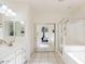Bright main bathroom with dual sinks, a large mirror, and a glass enclosed shower at 9998 W Prospector Dr, Queen Creek, AZ 85144