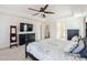 View of the main bedroom featuring neutral carpet, a large window, and dark wood furniture at 9998 W Prospector Dr, Queen Creek, AZ 85144