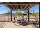 Enjoy the shade from this outdoor seating under a pergola with a ceiling fan and a great view of the horse pastures at 9998 W Prospector Dr, Queen Creek, AZ 85144