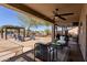 Comfortable patio features multiple seating arrangements and relaxing views of the backyard at 9998 W Prospector Dr, Queen Creek, AZ 85144
