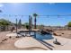 Relaxing pool with umbrellas and a small rock waterfall, perfect for enjoying sunny days in a private setting at 9998 W Prospector Dr, Queen Creek, AZ 85144