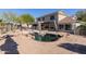 Inviting backyard pool with rock accents, ideal for cooling off and enjoying the beautiful outdoor living space at 9998 W Prospector Dr, Queen Creek, AZ 85144