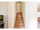 Tiled staircase illuminated by wall lights leading to the upper level of the home at 9998 W Prospector Dr, Queen Creek, AZ 85144