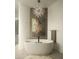 Elegant bathroom featuring a stand alone tub, a stylish light fixture, and minimalist decor at 10040 E Happy Valley Rd # 1011, Scottsdale, AZ 85255