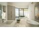 Bright bathroom with custom cabinets, a soaking tub, modern fixtures, and a desert view at 10040 E Happy Valley Rd # 1011, Scottsdale, AZ 85255