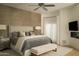 Serene bedroom with a king-size bed, decorative wall, and a ceiling fan for added comfort at 10040 E Happy Valley Rd # 1011, Scottsdale, AZ 85255