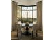 Dining area with a chandelier and large windows offering natural light and scenic views at 10040 E Happy Valley Rd # 1011, Scottsdale, AZ 85255