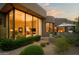 Southwestern-style home with large windows, desert landscaping, and an outdoor seating area at 10040 E Happy Valley Rd # 1011, Scottsdale, AZ 85255