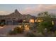 Desert home with a three-car garage, complemented by lush desert landscaping and mountain views at 10040 E Happy Valley Rd # 1011, Scottsdale, AZ 85255