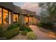 Inviting front entrance with desert landscaping, warm lighting, and a charming southwestern architectural design at 10040 E Happy Valley Rd # 1011, Scottsdale, AZ 85255
