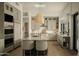 Bright, open kitchen with a large island, modern appliances, custom cabinets, and a stylish woven light fixture at 10040 E Happy Valley Rd # 1011, Scottsdale, AZ 85255