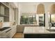 Spacious kitchen with custom cabinets, stone countertops, pendant lighting, and views of the backyard at 10040 E Happy Valley Rd # 1011, Scottsdale, AZ 85255